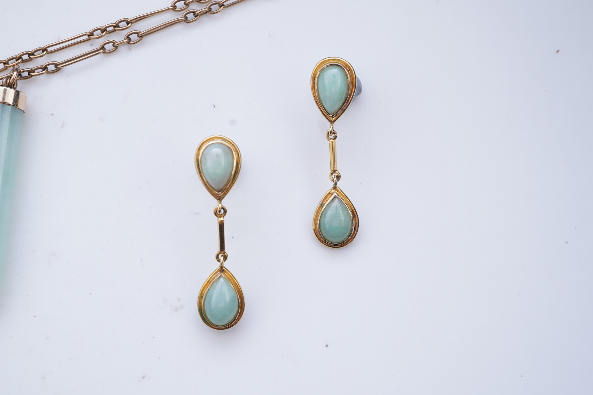 A jadeite pendant and pair of earrings